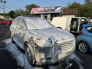 An SUV getting detailed in a parking lot by On Point Detail Pro in NJ